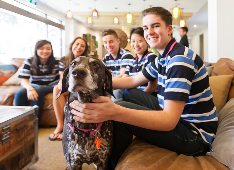 St Catherine's College residents on couch with college dog