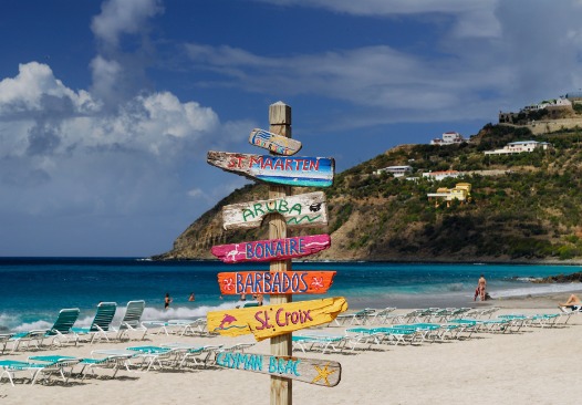 Signpost of Caribbean islands on the beach at St Maarten