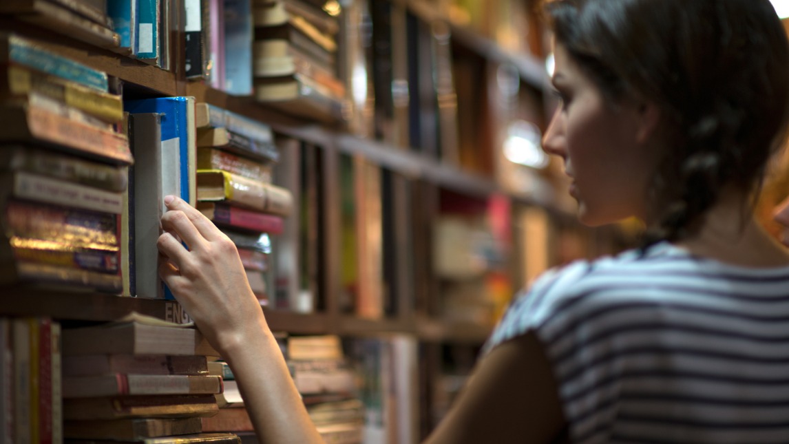 woman browsing library shelf