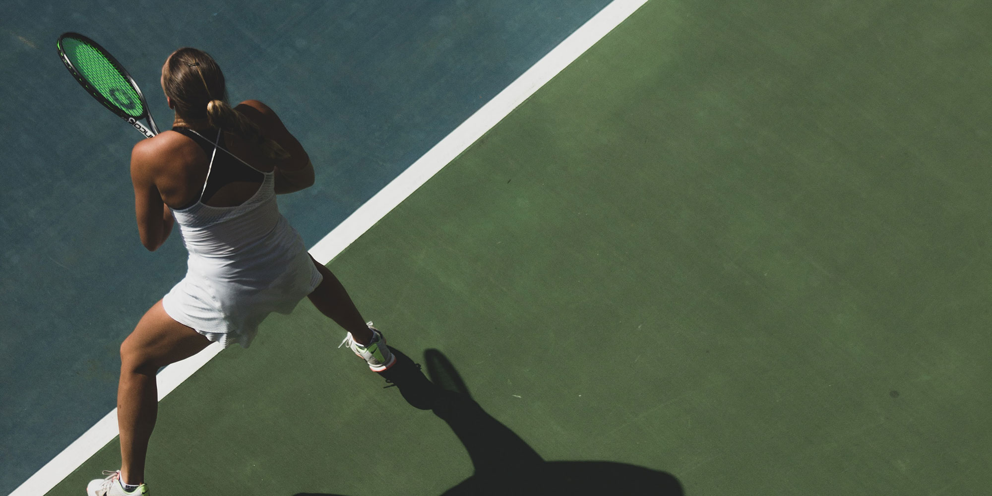 Elite tennis player on court preparing to return a serve