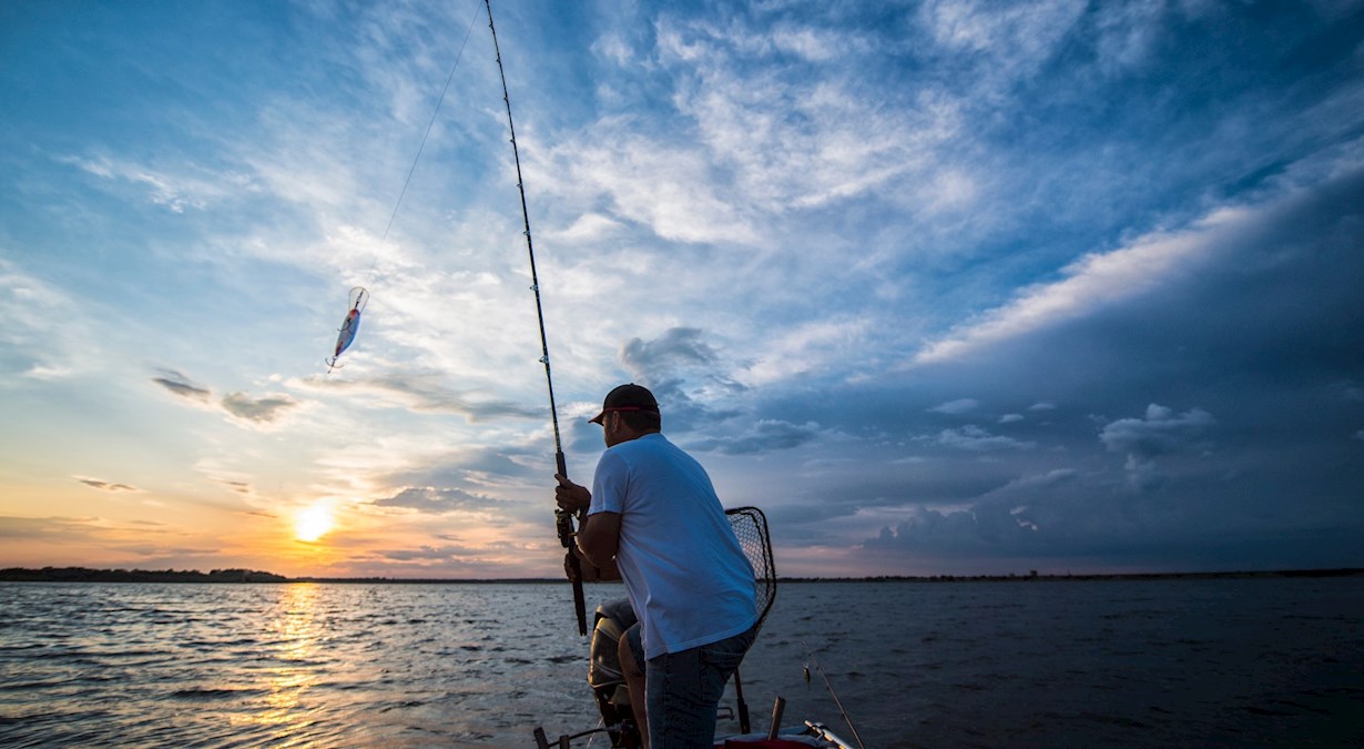 man fishing at sunset