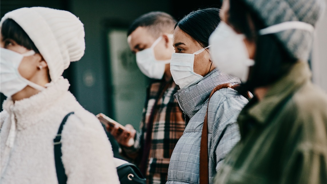 Four people wearing face masks