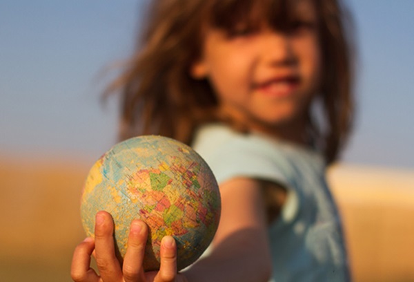 girl holding a toy globe