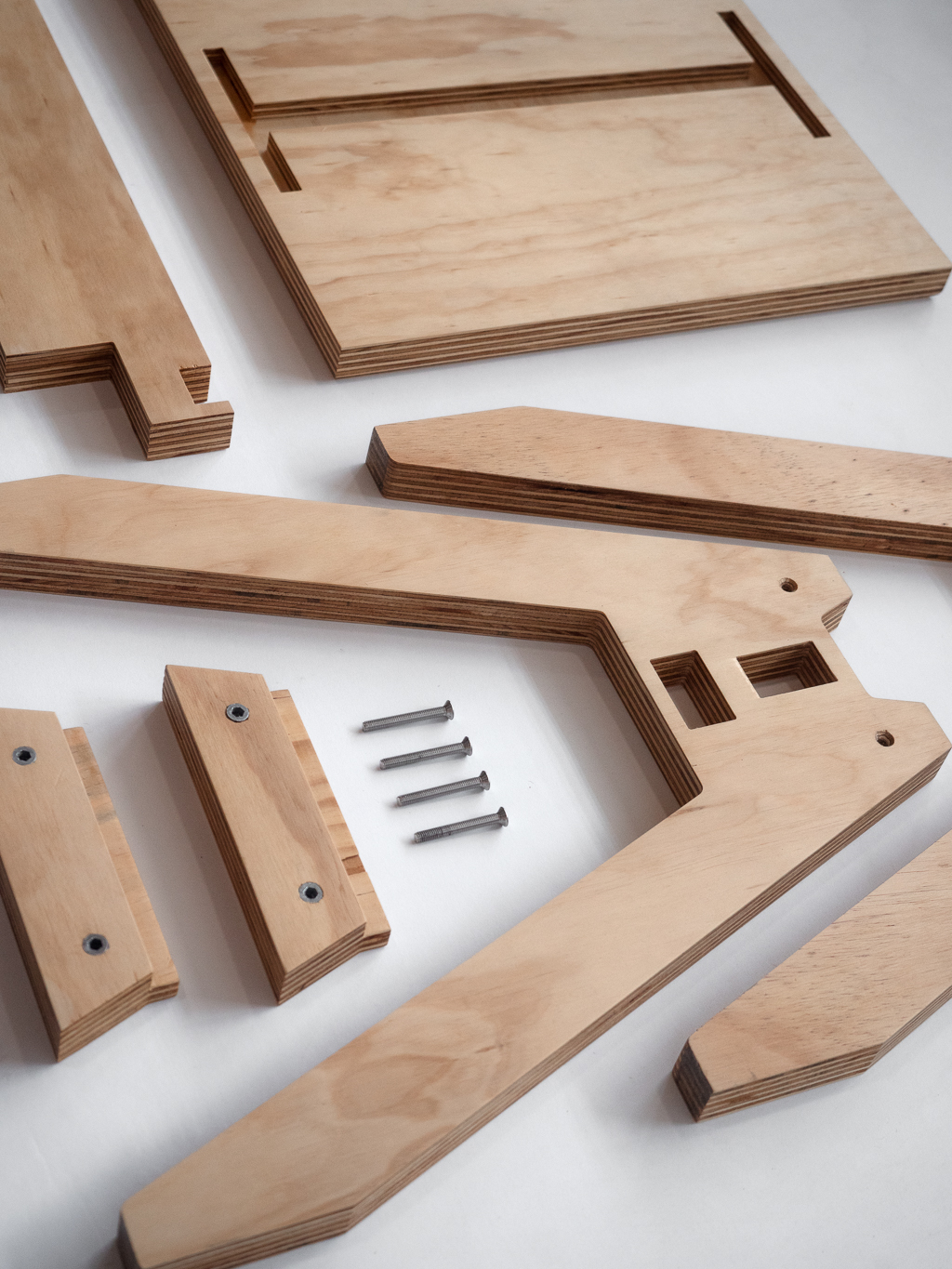 A disassembled wooden pavilion stool