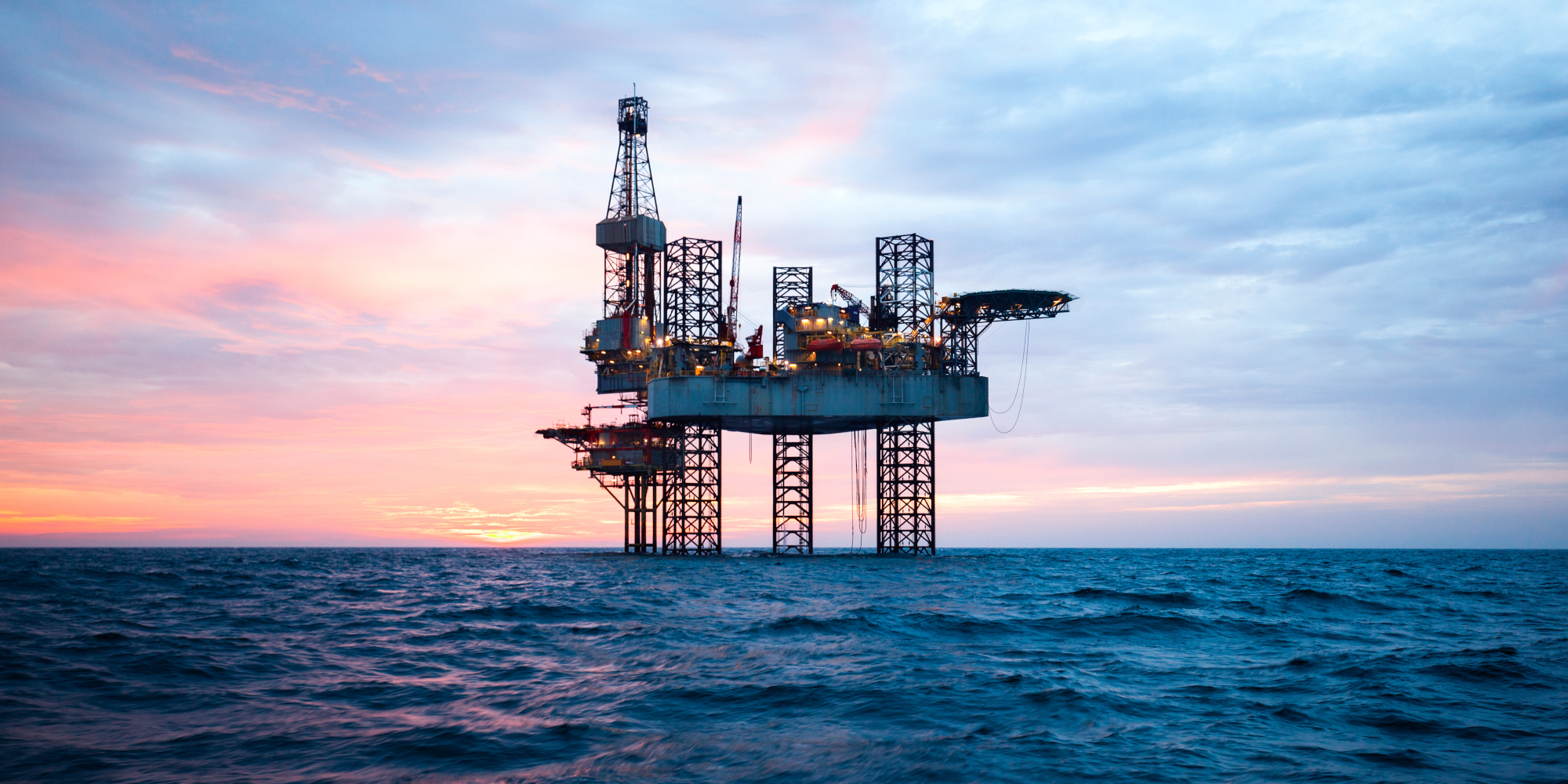 Mining rig in the sea with sunset in background