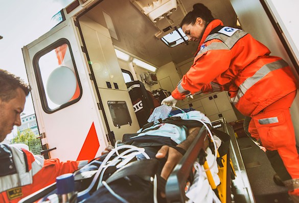 image of paramedics loading a patient into an ambulance