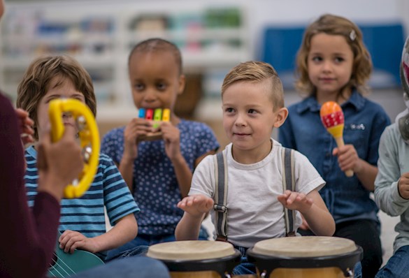 Early learner children playing musical instruments