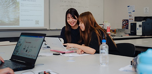 Students viewing a laptop at the UWA Claremont campus