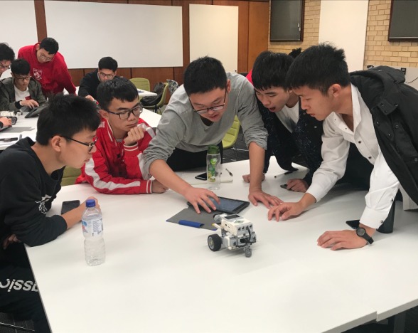5 robotics students in workshop
