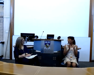 Professor Sarah Murray speaking with Associate Professor Yee-Fui Ng at the front of a lecture theatre