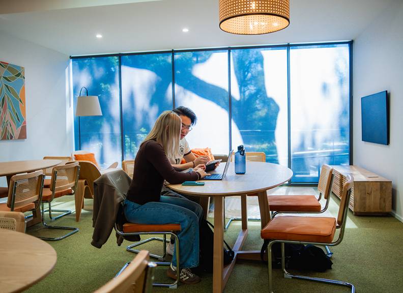 Image of two students sitting in a room at University Hall