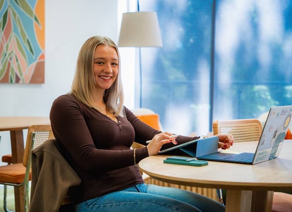 Image of a student studying at a common area at University Hall