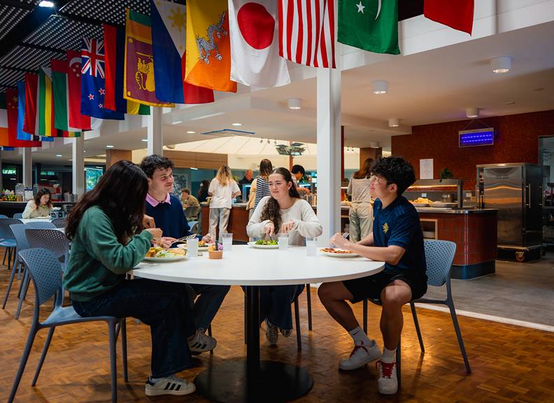 Image of students sitting at a dinning hall in Trinity College