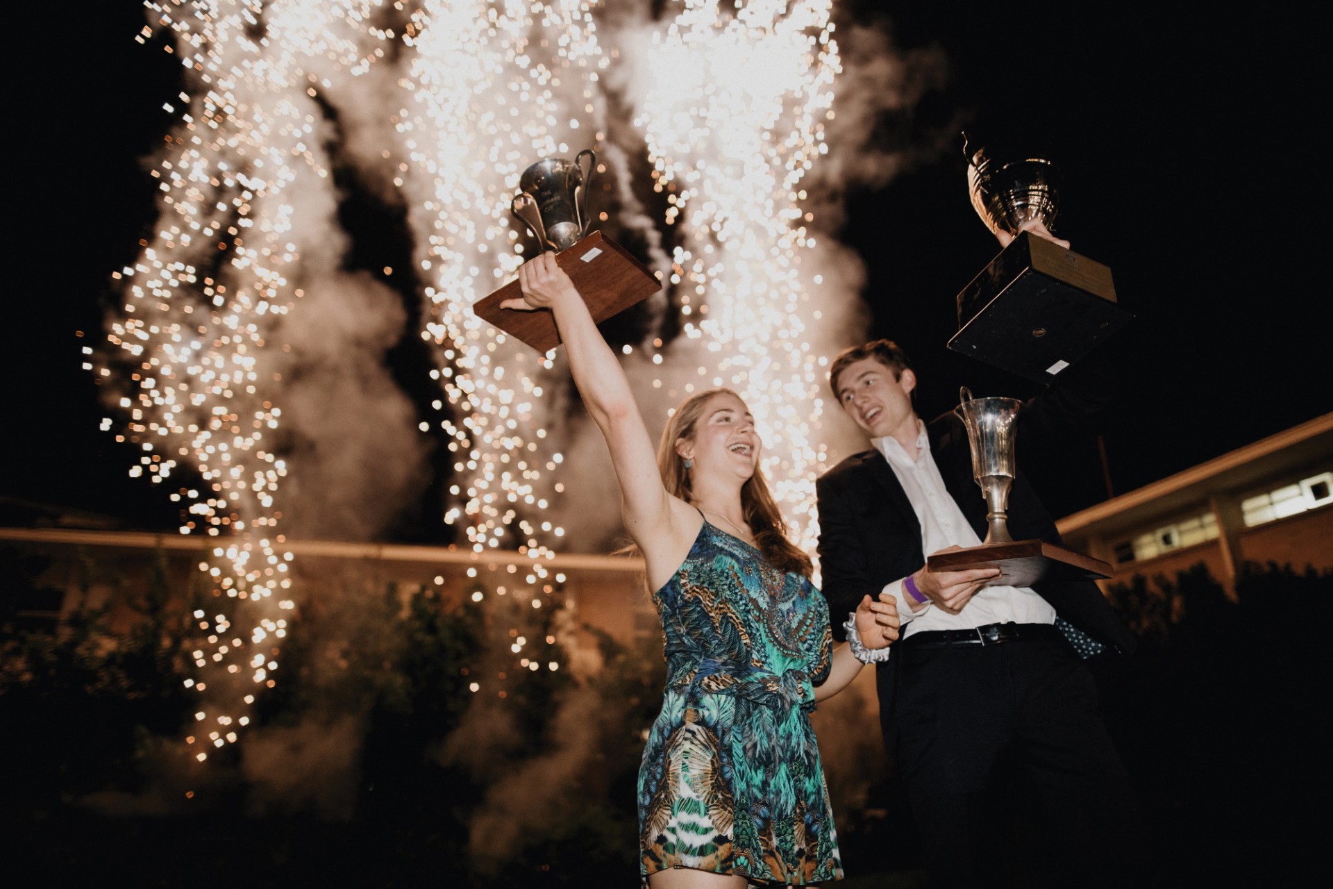 Picture of two young people in front of fireworks