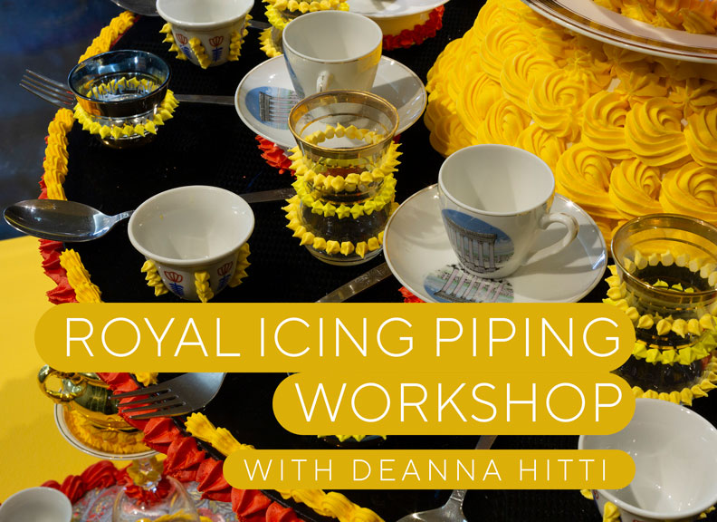 A colourful table setting with piped icing decorating the table and tableware