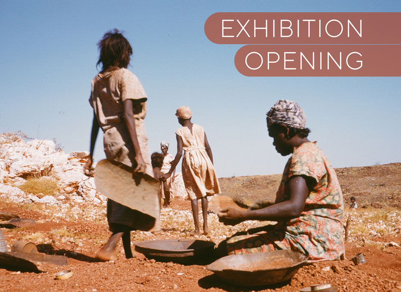 Old photo of Indigenous women working in the outback landscape - they have what look like Coolaman tools for carrying