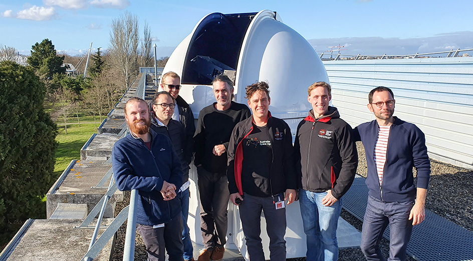 Members of the project team standing in front of a telescope dome located at the CNES campus in Toulouse, containing one of the self-guiding optical terminals. Credit: ICRAR/UWA.
