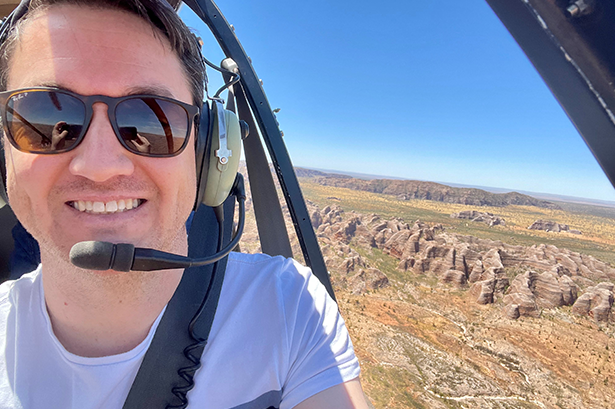 Man in a helicopter flying over the Bungle Bungles