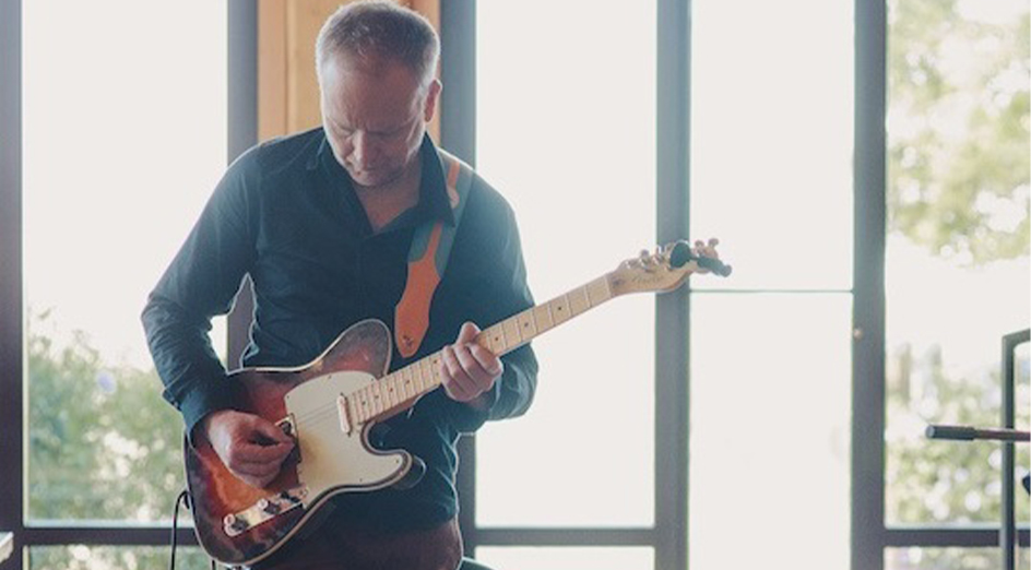 James Ledger playing guitar