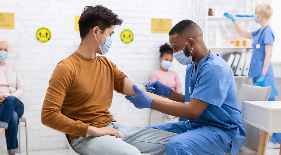 Asian male getting vaccine