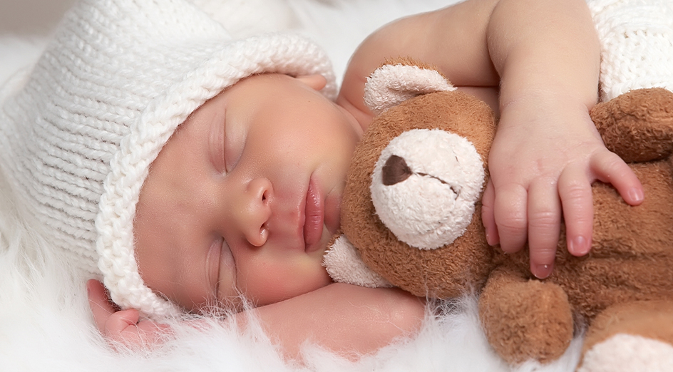 Small baby with teddy bear
