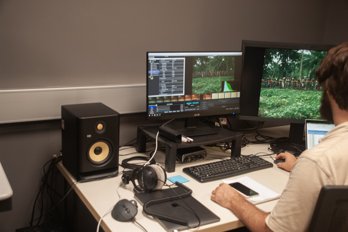 A digitisation officer monitoring the colour grading of a film while it is being digitised. Image pixel length is 1200.