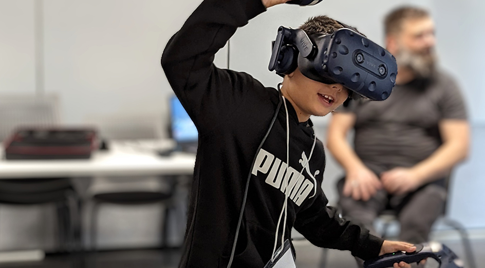 Young boy playing VR game