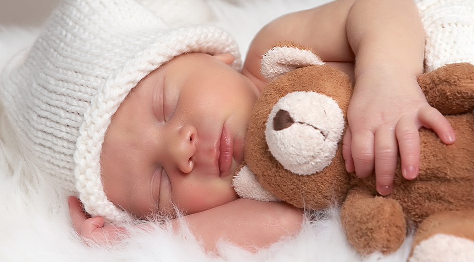 Little baby holding teddy bear
