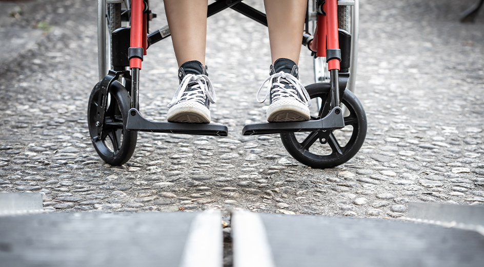 Child in wheelchair, just legs in view