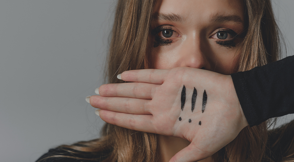 Woman with hand in front of face