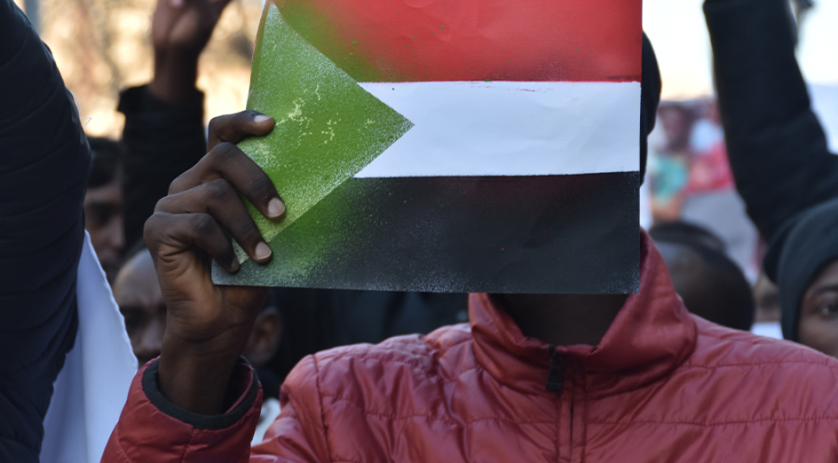 Sudanese man holding flag