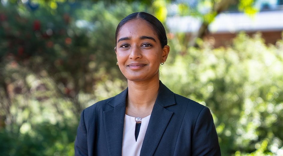 2026 Rhodes Scholar Fatima Merchant pictured in front of blurred greenery