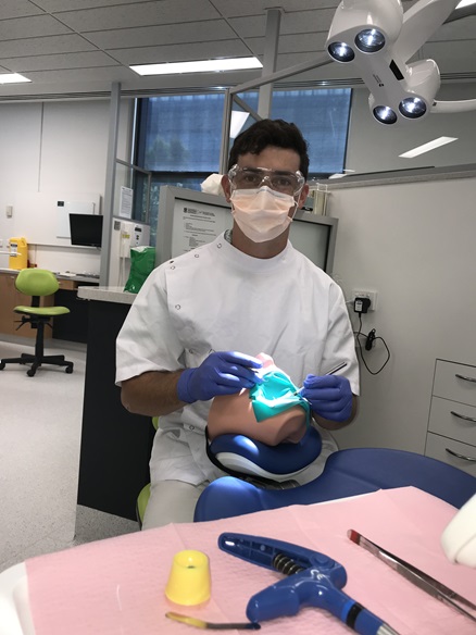 Dental Student Jim Rae practicing on a dental simulation head