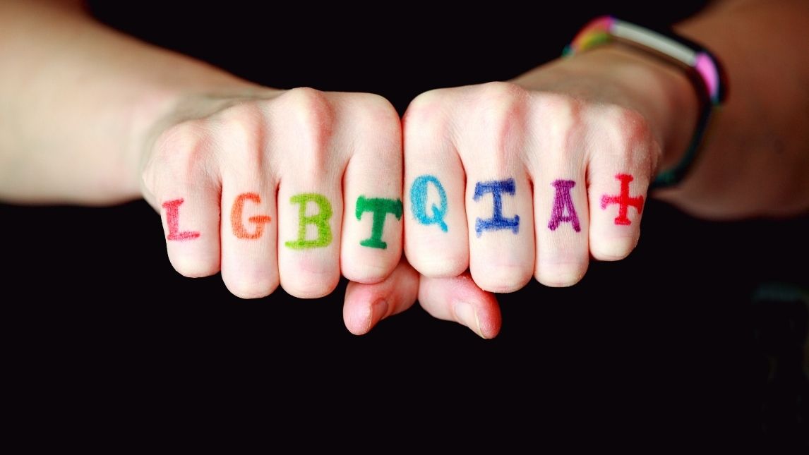 Two hands supporting LGBTQIA+