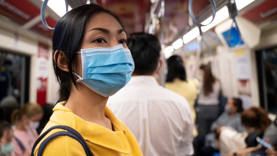 Girl on train with mask
