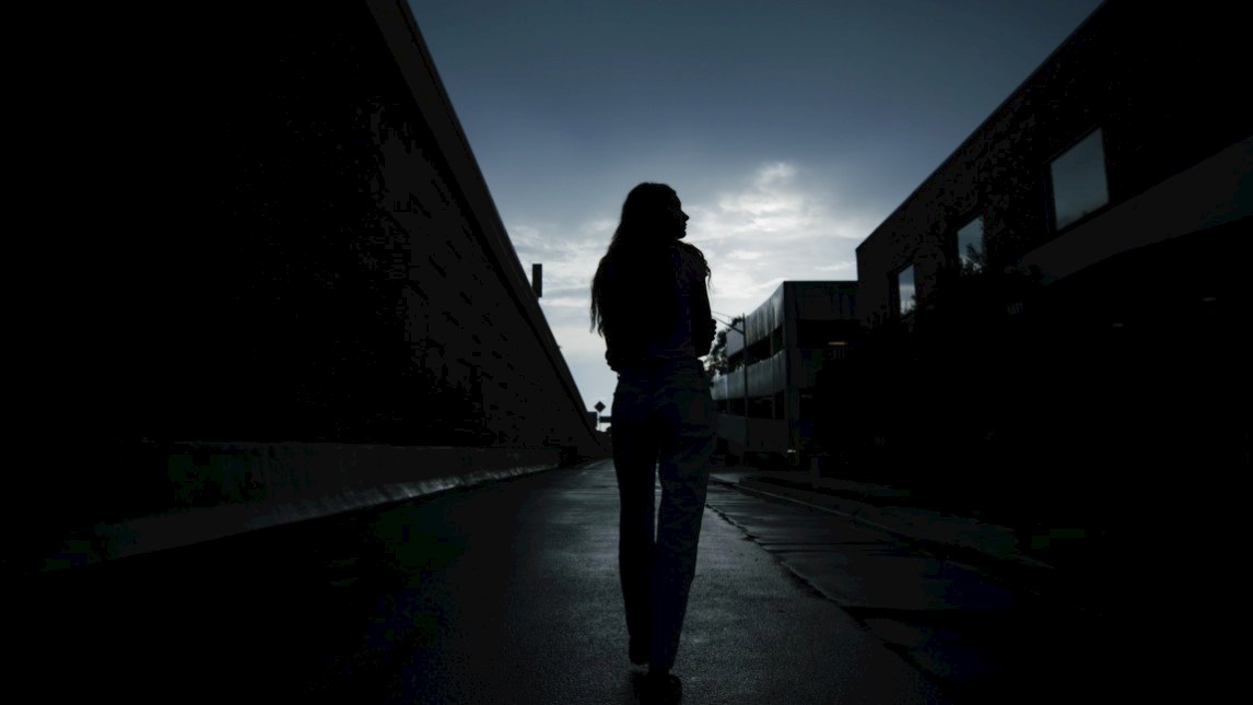 Woman walking in the dark