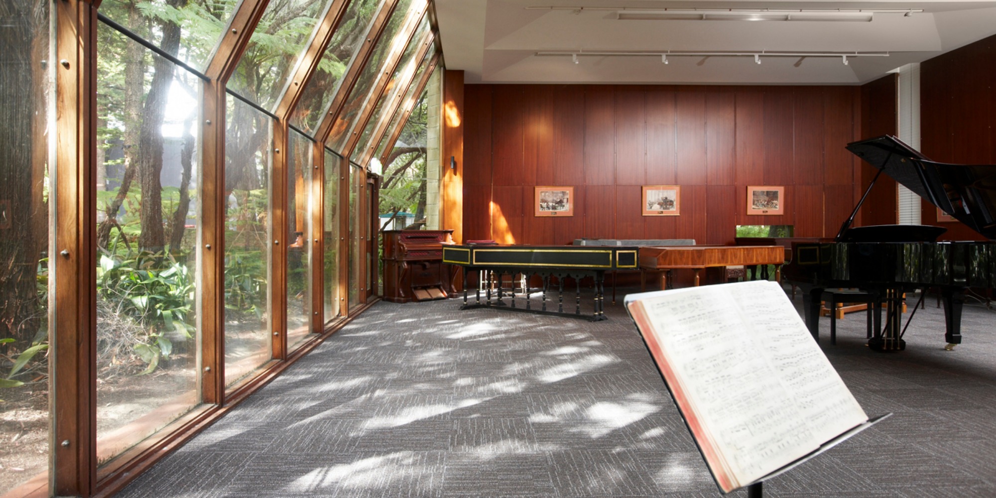 Music room with music stand and several pianos