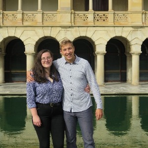 Rachel Bannerman and Paris Buti standing in front of Winthrop Hall and Reflection Pond