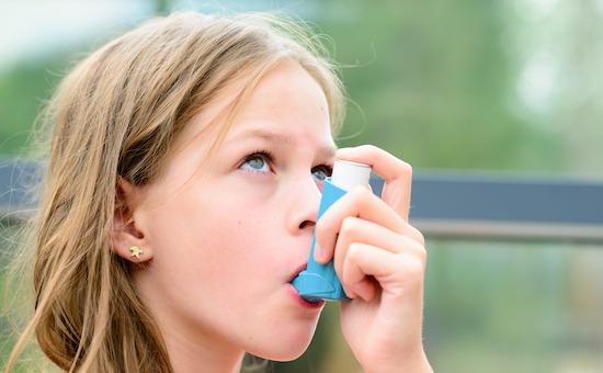 Child using Salbutamol inhaler
