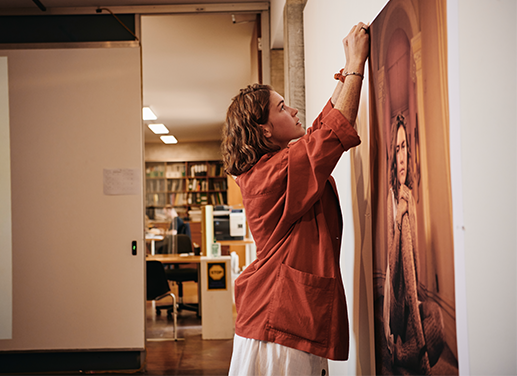 student hanging up picture