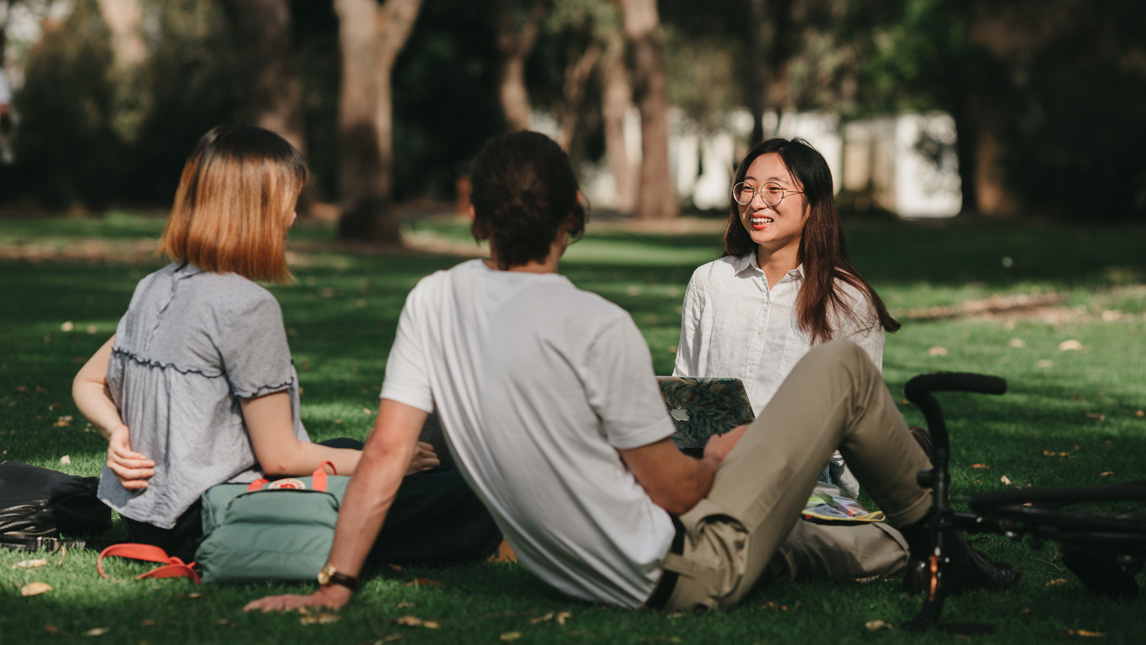 Students sitting and talking on University grounds