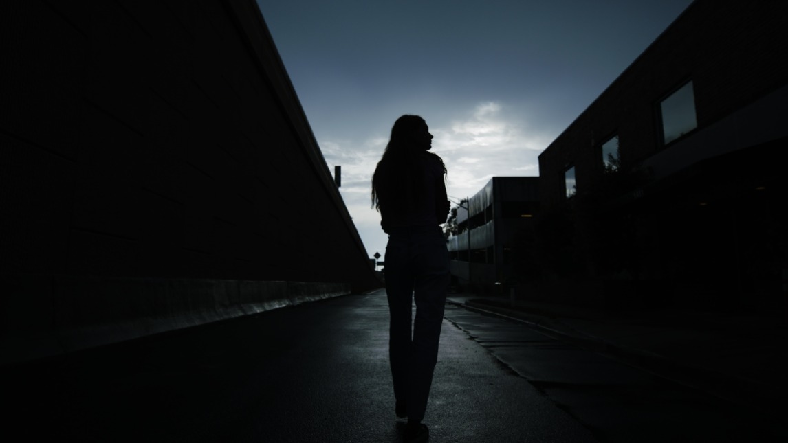 Woman walking in the dark