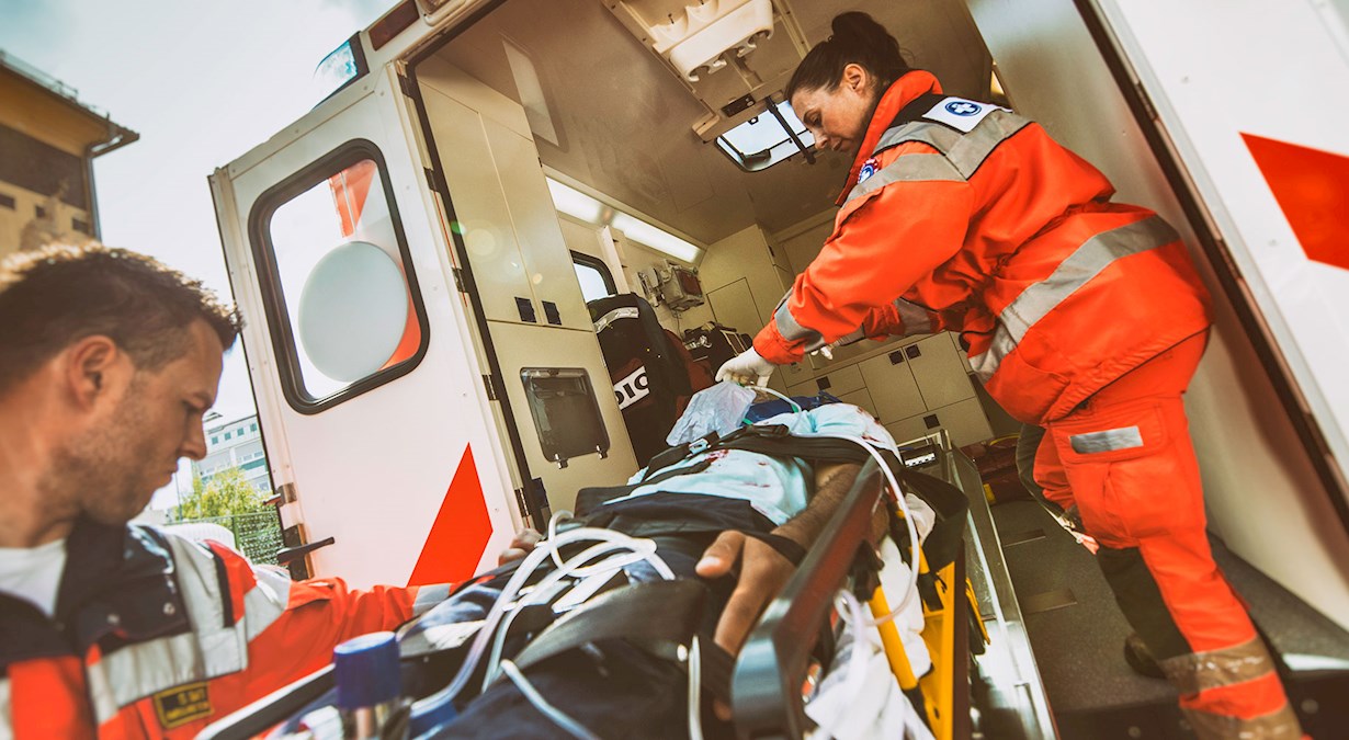 image of paramedics loading a patient into an ambulance