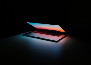 Glowing laptop in dark