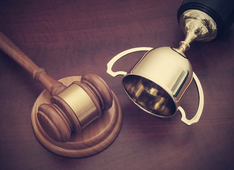 Gavel and trophy on desk