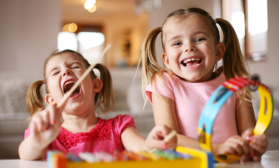 Pre kindergarten aged children playing musical instruments