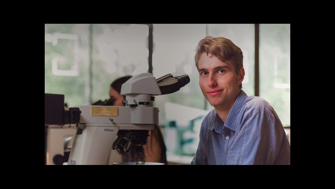 Science student working with microscope
