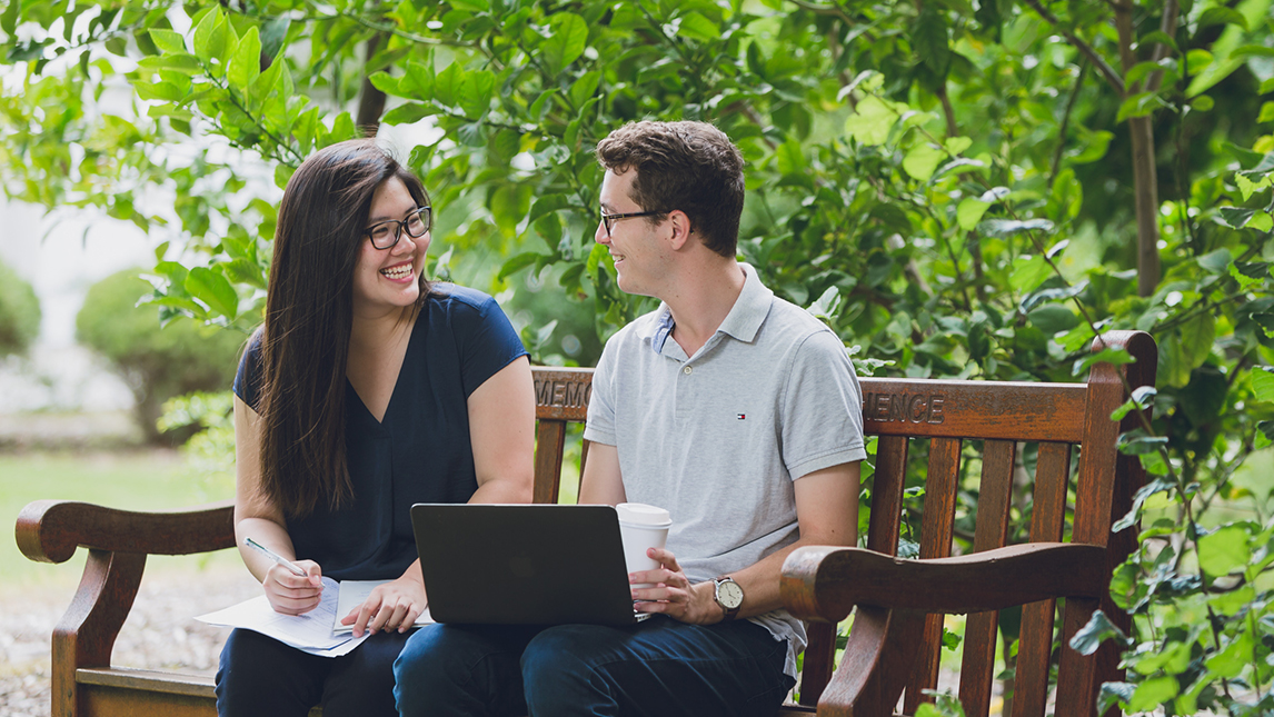 two students on a bench