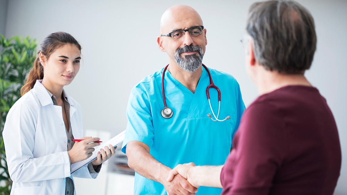 Doctor shaking hands with patient 