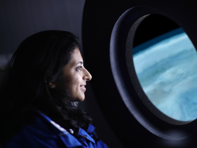 woman looking out plane window
